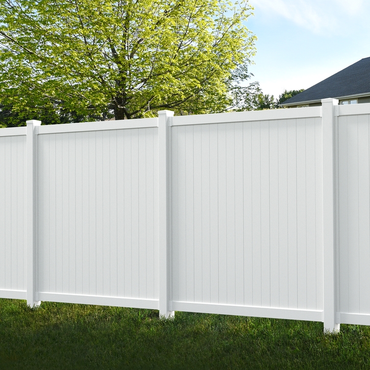 Cambridge white vinyl privacy fence panels installed in a backyard with reinforced posts, creating a full-height, maintenance-free privacy fence