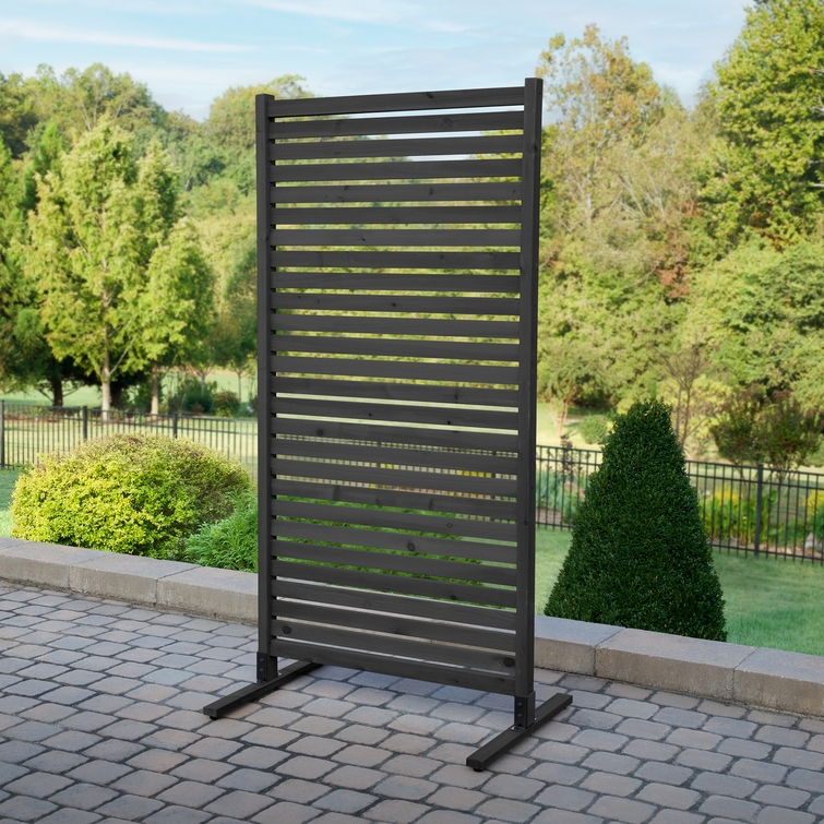 Charcoal Enclo Tiaga privacy screen panel freestanding on a patio with horizontal slats for modern outdoor privacy and airflow