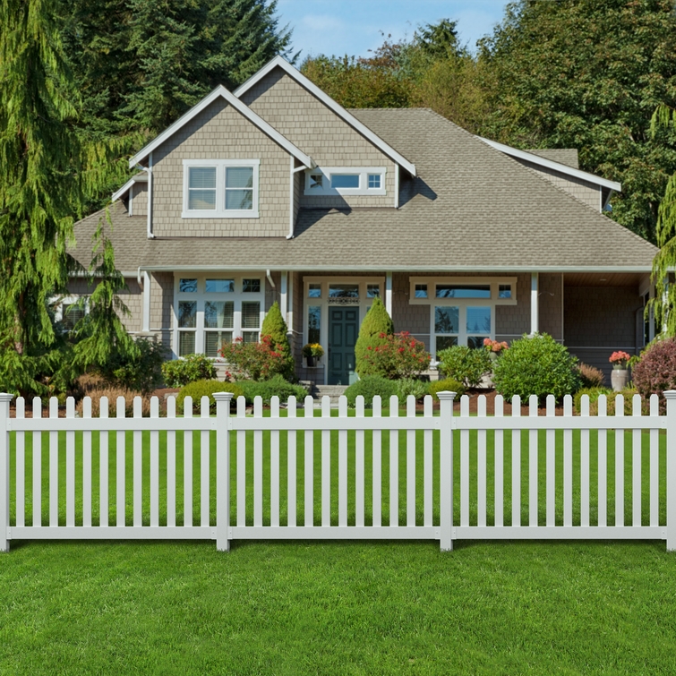 All-American flat top white vinyl picket fence installed across a lawn in front of a suburban home