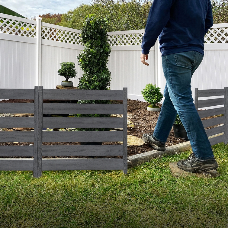 Freestanding WoodTek vinyl fence panels creating low profile garden border in backyard landscape