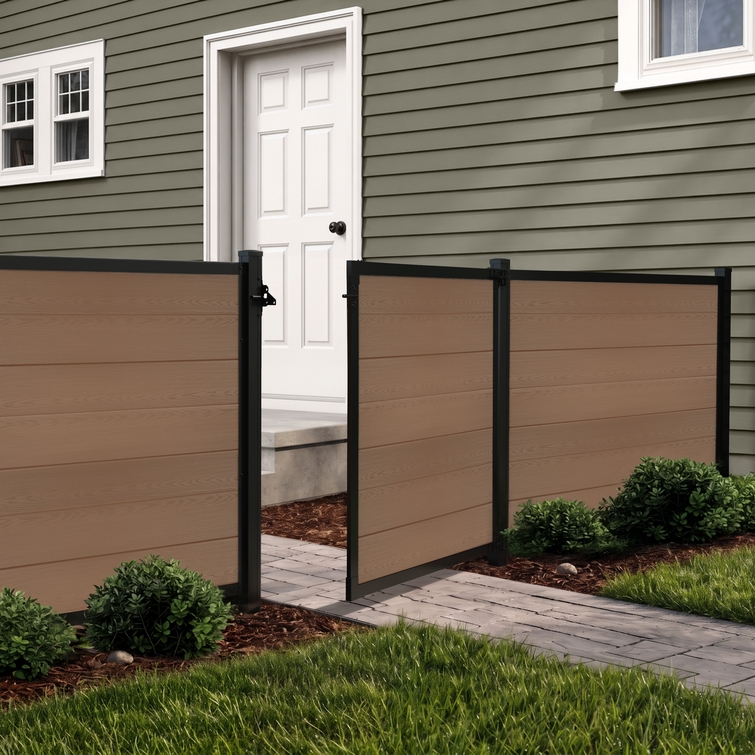 4 ft tall composite privacy fence with walnut brown composite boards, black aluminum frame, and matching walk gate installed in a residential backyard.