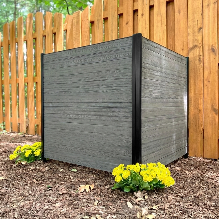 Outdoor AC unit privacy screen enclosure with gray woodgrain composite panels and black aluminum posts