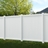 Cambridge white vinyl privacy fence panels installed in a backyard with reinforced posts, creating a full-height, maintenance-free privacy fence