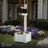 White vinyl mailbox post with integrated planter box installed in landscaped front yard with flowers