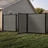 6 ft tall composite privacy fence with slate gray composite boards, black aluminum frame, and matching walk gate installed in a residential backyard.