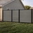 6 ft tall composite privacy fence with slate gray composite boards, black aluminum frame, and closed matching walk gate in a residential backyard.