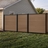 6 ft tall composite privacy fence with walnut brown composite boards, black aluminum frame, and closed matching walk gate in a residential backyard.
