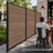 Edgewood aluminum fence with wood-look composite panels forming a privacy screen beside an outdoor patio dining area