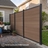 Edgewood aluminum privacy fence installed along a backyard patio where a woman relaxes on a bench