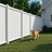Modern white vinyl privacy fencing surrounding backyard lawn with family-friendly outdoor security and pet containment