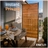 Enclo outdoor wood privacy screen panel on an apartment balcony, featuring horizontal cedar-stained slats and a black aluminum frame for instant privacy on patios, decks, balconies, and outdoor living spaces